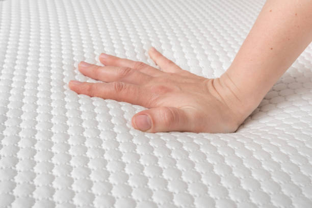 istock Woman is choosing new mattress for good sleeping 1146406823