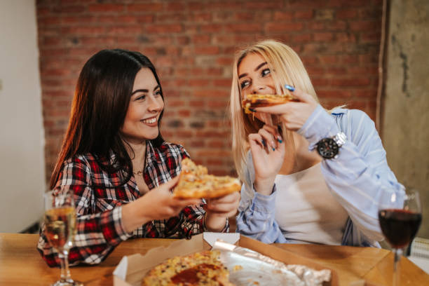istock Friends eating pizza indoors 1146408151