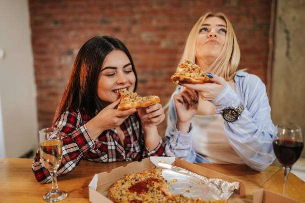 istock Friends eating pizza indoors 1146408379