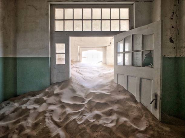 Namibia Ghost Town Abandoned Hospital Corridor Full of Sand Desert sand entering old abandoned hospital building ín old deserted Ghost Town. Luderitz, Namibia, Africa. kolmanskop namibia stock pictures, royalty-free photos & images