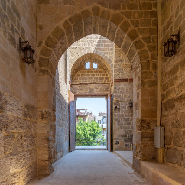 istock Passage at Al-Muayyad Bimaristan (hospital) historic building with stone bricks wall, arches, and entrance door, Cairo, Egypt 1146415549