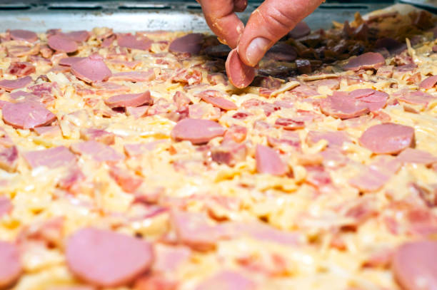 Making Pizza Workshop Concept. Female Hand Adds Pizza Ingredients.