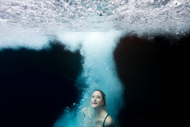 istock A woman underwater in a dark ocean 1146417595