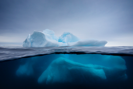 Under and over water view of an iceberg in Crystal Sound, Antarctic Peninsula