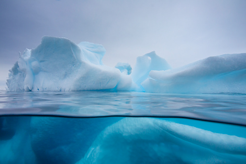 Under and over water view of an iceberg in Crystal Sound, Antarctic Peninsula