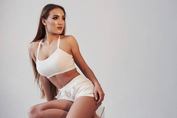 istock Clean studio. Portrait of seductive brunette in the studio with white background 1146418597