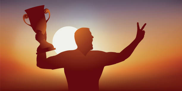 istock A high-level athlete raises the winner's Cup and makes the victory sign. 1146420239