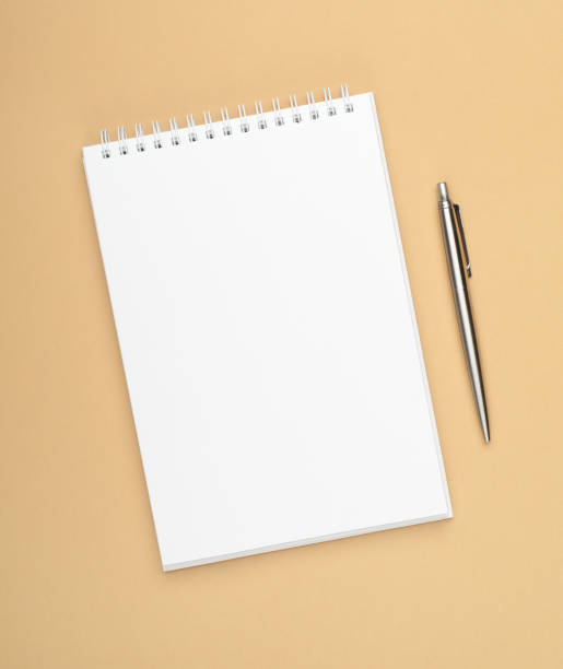 istock White notebook with steel pen on a brown background. Office, save space, mock up, template, top view, flat lay. 1146420367