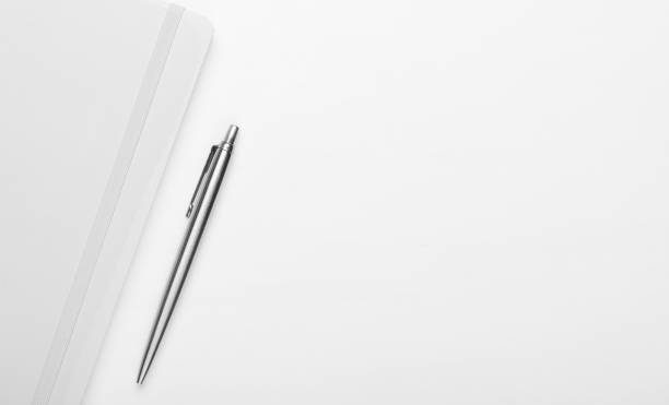 istock White notepad with steel pen on a white wooden background. Minimal composition, save space, top view, flat lay. 1146420394