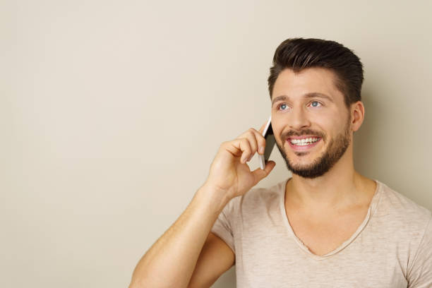istock Young bearded man talking on phone 1146429210