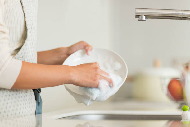 istock Housewife washing dishes 1146433617
