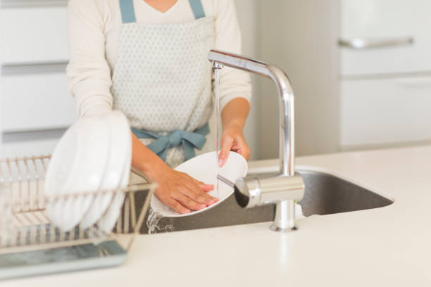 istock Housewife washing dishes 1146433636