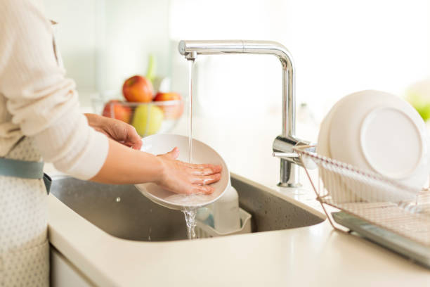 Housewife washing dishes Person washing dishes stock pictures, royalty-free photos & images