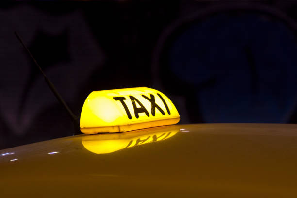 Illuminated yellow taxi sign from Athens in Greece.