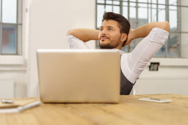 istock Young bearded man relaxing in chair at office 1146437608