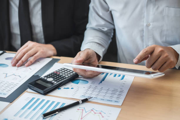 istock Colleagues Working At Desk In Office 1146439314