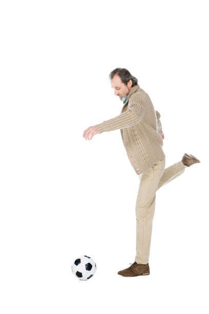 istock cheerful retired man playing football isolated on white 1146439372