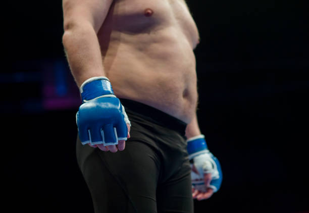 istock Midsection Of Shirtless Boxer Standing In Boxing Ring 1146440713