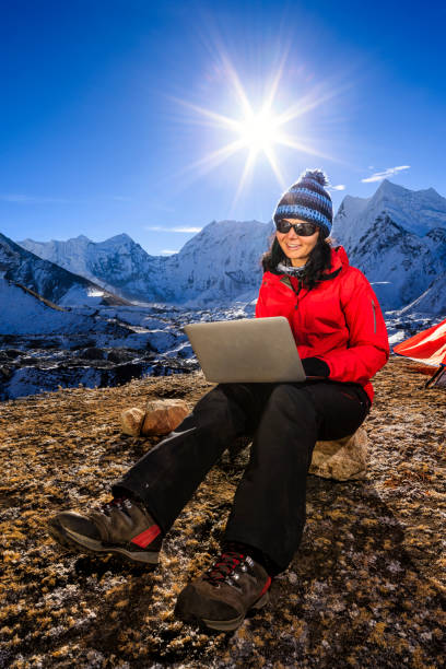 istock Young woman using laptop in Himalayas, Nepal 1146441089