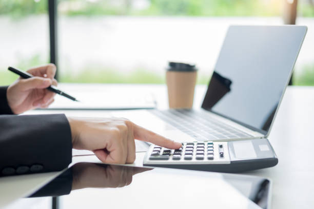 istock Cropped Image Of Businesswoman Using Calculator In Office 1146441993