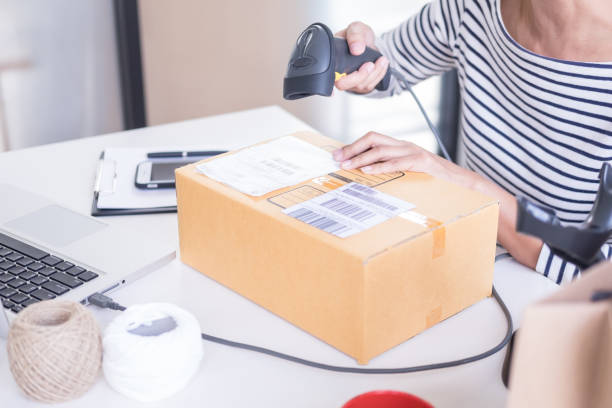 istock Midsection Of Woman Scanning Cardboard Box 1146442130