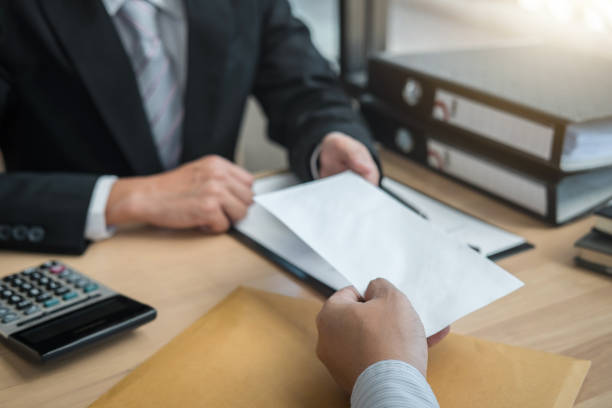 istock Cropped Hand Giving Envelope To Businessman At Office 1146442148