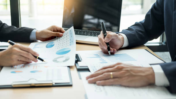 istock Midsection Of Businessman Writing On Graph Chart At Office 1146442220