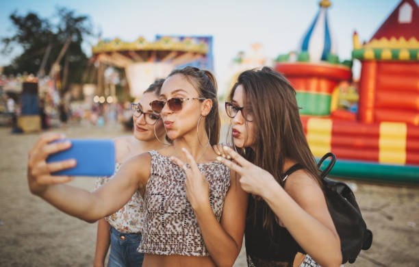 istock Girls taking selfies by inflatable castle 1146442315