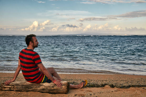 istock Man enjoying on a deserted tropical beach. 1146444410