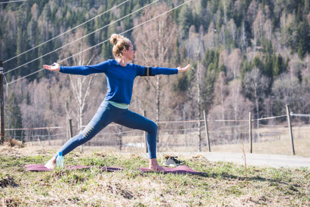 istock Young woman doing yoga warrior pose exercise. 1146445177