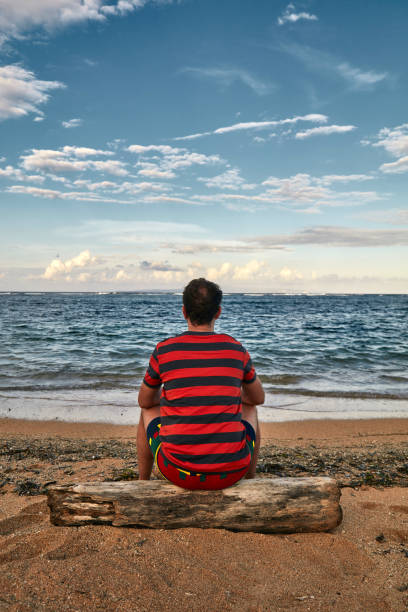 istock Man enjoying on a deserted tropical beach. 1146445780