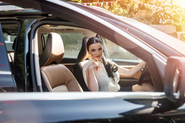 istock Woman with keys inside car on driver seat 1146448198