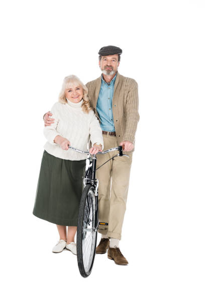 istock cheerful pensioner hugging wife while holding bicycle isolated on white 1146448736