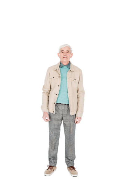 istock happy senior man smiling while standing isolated on white 1146448758