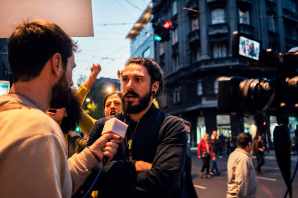 Young protesters Young protesters give's interview for TV news journalist stock pictures, royalty-free photos & images