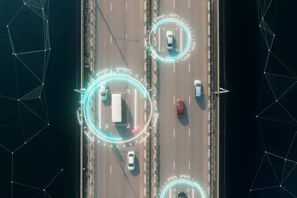 Photo of 4k aerial view of self driving autopilot cars driving on a highway with technology tracking them, showing speed and who is controlling the car. Visual effects clip shot.