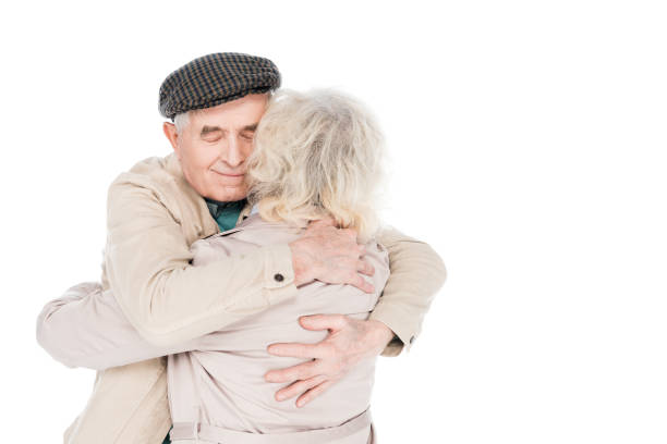 istock happy retired man hugging wife isolated on white 1146449614