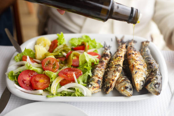 istock grilled sardines with salad and olive oil on white dish 1146449907