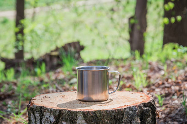 istock Metal mug on background of forest 1146449935