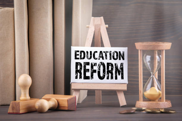 istock Education reform concept. Sandglass, hourglass or egg timer on wooden table 1146450979