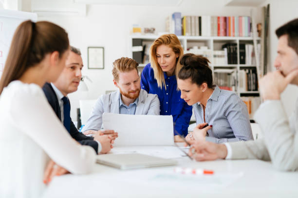 istock Group of business people working as team in office 1146451040