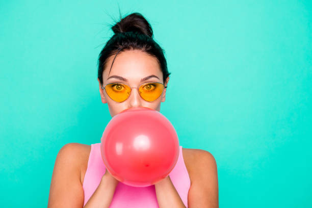close up photo beautiful funky hairstyle she her lady hold hands arms big air balloons blowing breath weekend childish activity wear specs casual tank-top isolated bright teal turquoise background - inflating balloon blowing air imagens e fotografias de stock