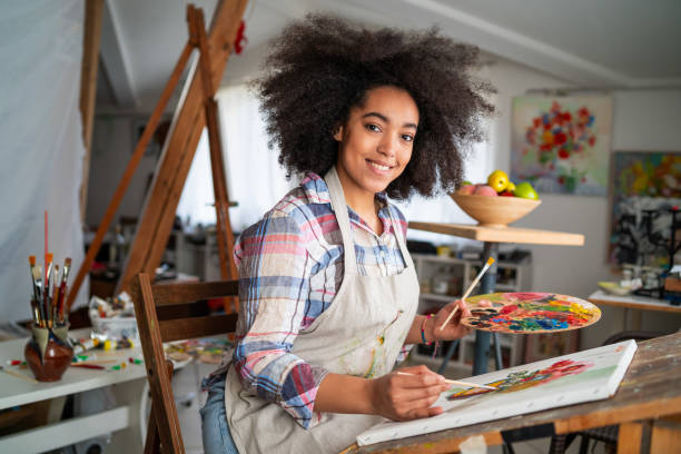 istock Young afro woman drawing 1146451308