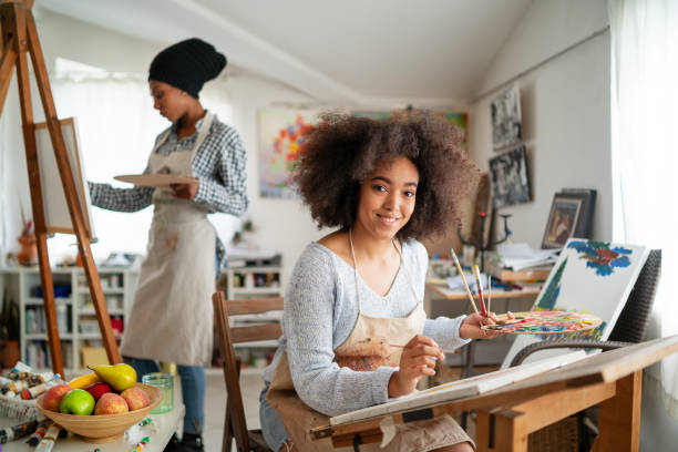 istock Afro Female fine artists drawing in studio 1146451309