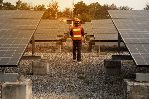 istock The worker in uniform and helmet checks Solar cell. 1146451477