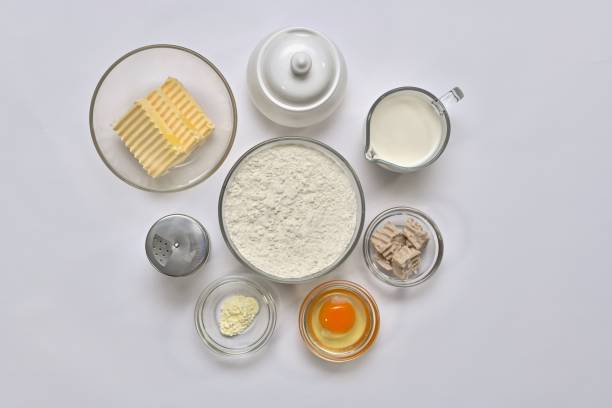 istock Ingredients for yeast dough. Each in a separate container: wheat flour, butter, vegetable fat, egg, sugar, salt, yeast, milk, baking powder. 1146451480