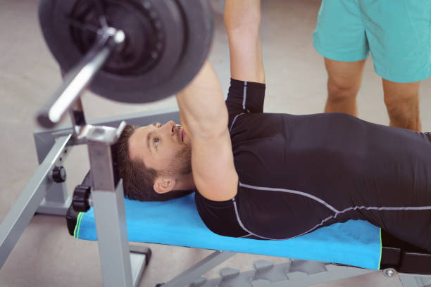 istock Healthy young male bodybuilder lifting weights 1146452121