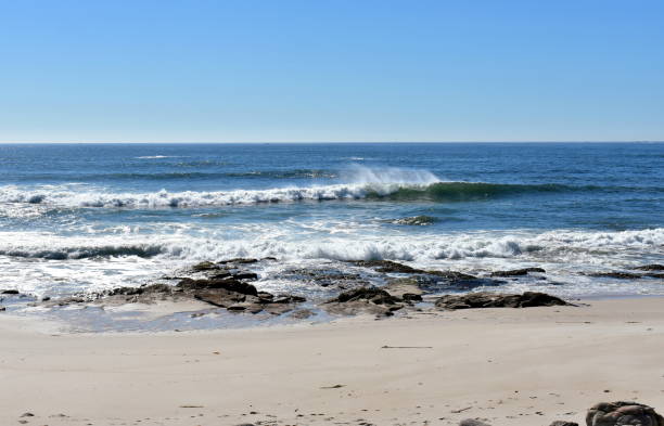 istock Beach with rocks and waves breaking. Blue sea, sunny day. 1146452423