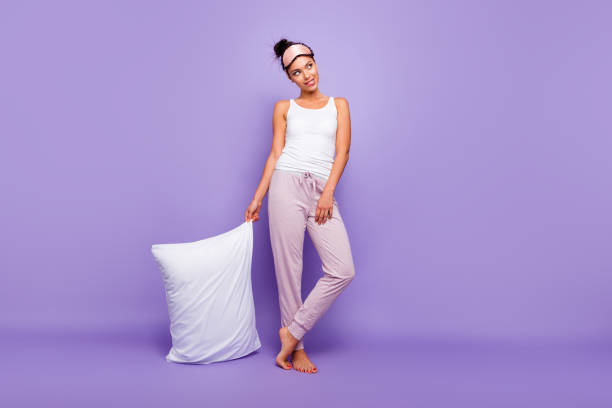 Full length body size photo beautiful she her lady look empty space wondered thoughtful hold hand arm pillow barefoot wear sleeping mask pants tank-top pajamas isolated violet purple background Full length body size photo beautiful she her lady look empty space wondered thoughtful hold hand arm pillow barefoot wear sleeping mask pants tank-top pajamas isolated violet purple background. pajamas stock pictures, royalty-free photos & images