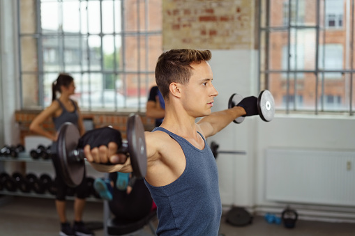 Man Extending Arm Man Extending Arms From Side With Weights Stock Photo - Download Image ...